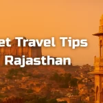 Budget travel tips for Rajasthan with view of Mehrangarh Fort and traditional sandstone architecture at sunset